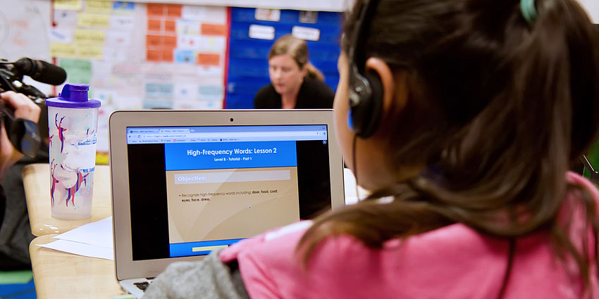 child working on computer in classroom