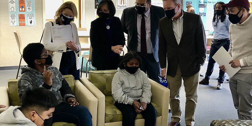 a group of students and adults conversing