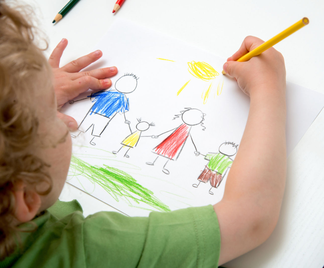 a child drawing a picture of a family